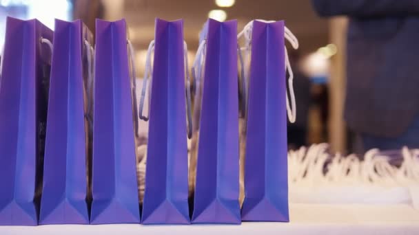 A business conference and presentation. Purple present package on a foreground — Stock Video