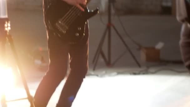 Un homme jouant de la guitare au groupe de rock. Éclairage lumineux — Video