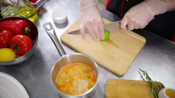 A chef working in the kitchen. Cutting the lime — Stock Video