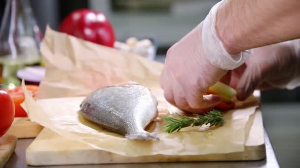 Mutfakta çalışan bir şef. Soğan ve domates ile balık doldurma — Stok video