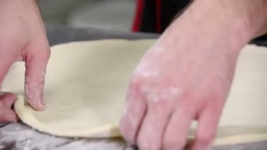 Restoran mutfağı. Pizza için bir hamur oluşturan bir şef