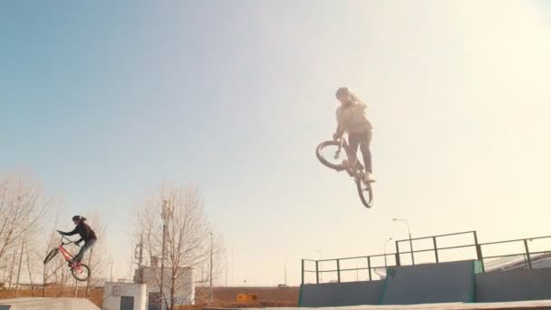 BMX jezdci cviči své dovednosti na skateparku s vysokou rychlostí — Stock video