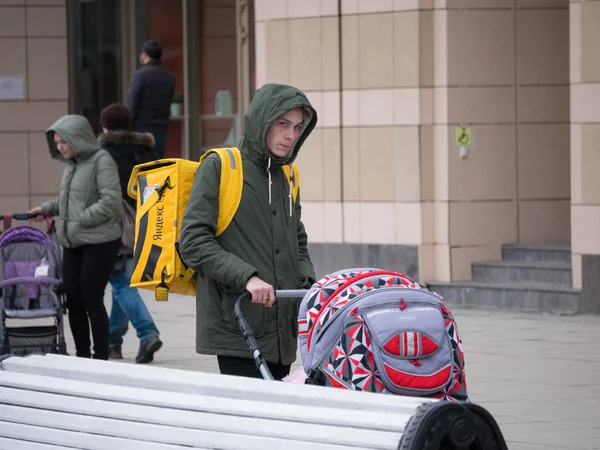 Rusland, Kazan 10-04-2019: stedelijke straten. Een Food delivery man met een kinderwagen — Stockfoto