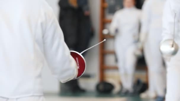 Teenage girls having a duel on a fencing tournament — Stock Video