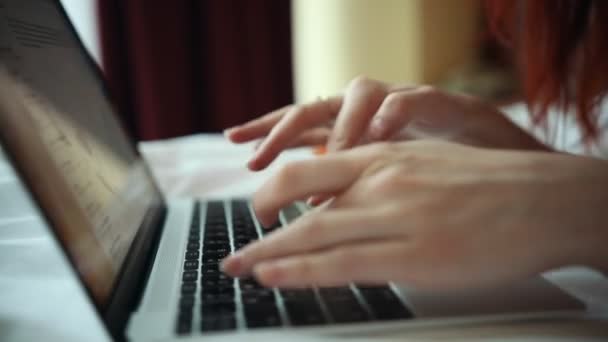 Een vrouw die werkt met een laptop in de hotelkamer — Stockvideo