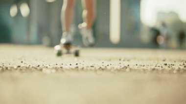 Genç kadın kaykay sürme - kameraya binmek ve durur