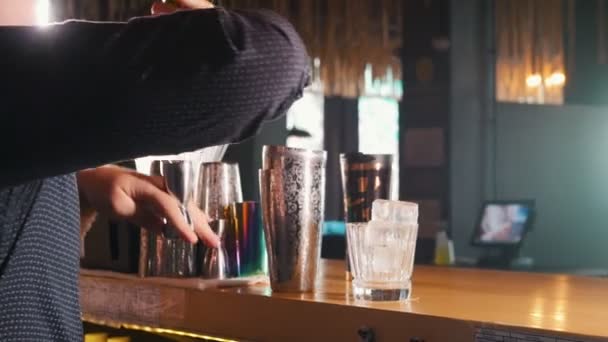Молодий професійний бармен ефективно вливає різні напої в шейкер — стокове відео