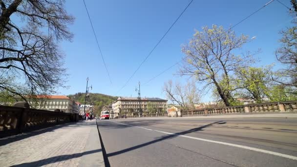 Ocupado camino en el puente en la ciudad checa Tranvía pasa a lo largo de la carretera — Vídeo de stock