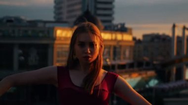 Çekici kadın gün batımında sokaklarda bale yapar - Yüzünde Güneş ışığı