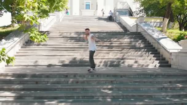 A young attractive tattooed man dancing on the stairs outdoors — Stock Video