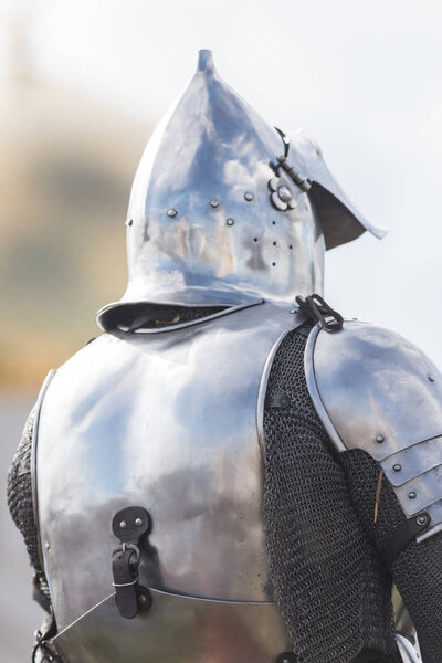 A man knight on the battlefield in iron helmet. Mid shot