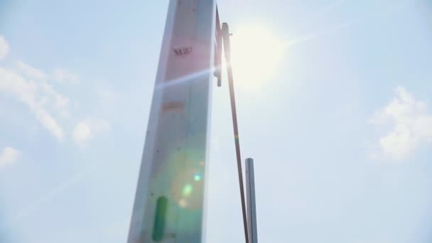 Pole vault training on the stadium outside- a woman jumping over the bar - sunny weather — Stock Video