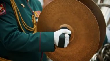 Bir rüzgarlı enstrüman askeri geçit töreni - yeşil kostümleri insanlar sokakta yürüyüş ve enstrümanlar çalmak - plakaları isabet bir adam