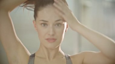 Saçlarını at kuyruğuna koyan bir kadın.