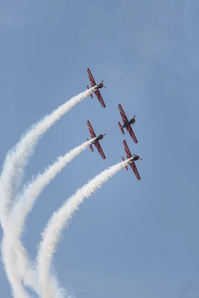 Vier militaire jets die synchroon in de blauwe lucht vliegen en een show uitvoeren die rook merken verlaat — Stockfoto