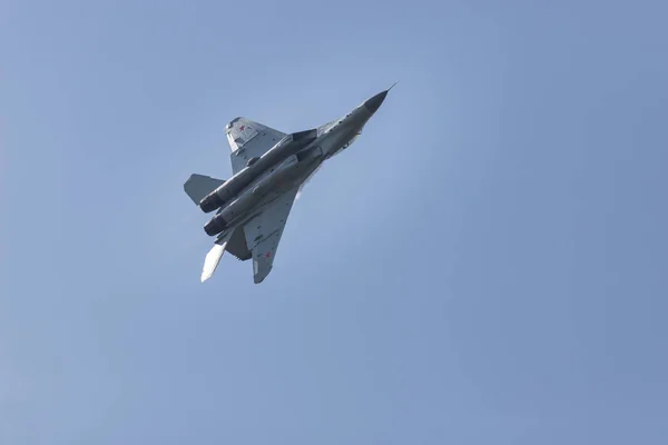 Een militaire straaljager met rode sterren op de vleugels vliegen in de lucht — Stockfoto