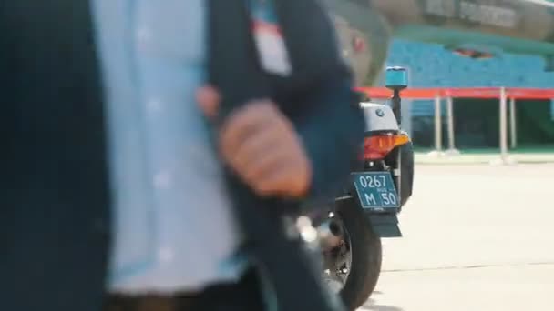 30 AUGUST 2019 MOSCOW, RUSSIA: an outdoors airplane exposition - a policeman riding a motorbike through the area — Stock Video