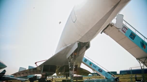 30 AUGUST 2019 MOSCOW, RUSSIA: An outdoors airplane exposition - Russian Aerospace Forces - supersonic passenger aircraft TU-144 - bottom view of the corpus — Stock Video