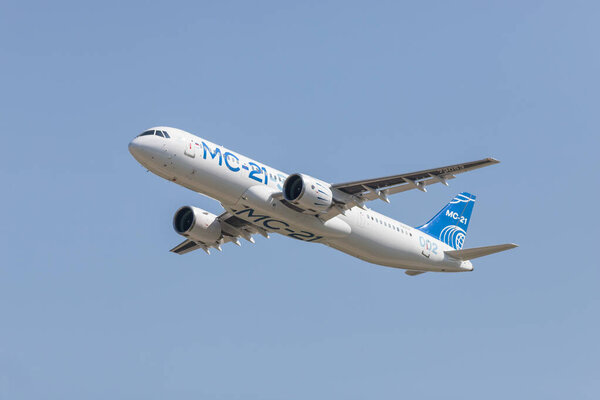 30 AUGUST 2019 MOSCOW, RUSSIA: A passenger plane flying in the clear blue sky - AIRBUS MC-21