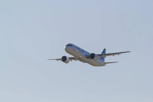 30. srpna 2019 Moskva, Rusko: Velká osobní letadla letící na jasně modré obloze - pohled zepředu - Airbus Mc-21 300 — Stock fotografie