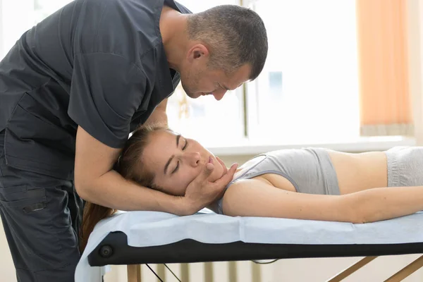 Tıbbi kabinede osteopati tedavisi gören genç bir kadın. — Stok fotoğraf