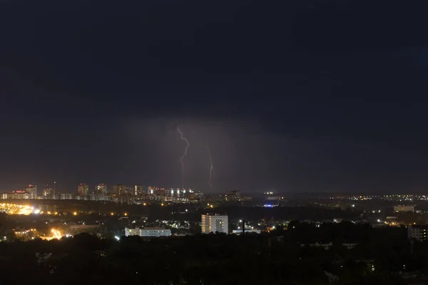 Two lightning flashes in the sky above the city