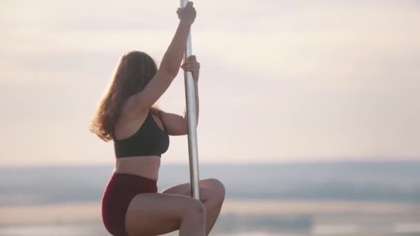 Jovem dançarina em roupas esportivas dançando pelo poste — Vídeo de Stock