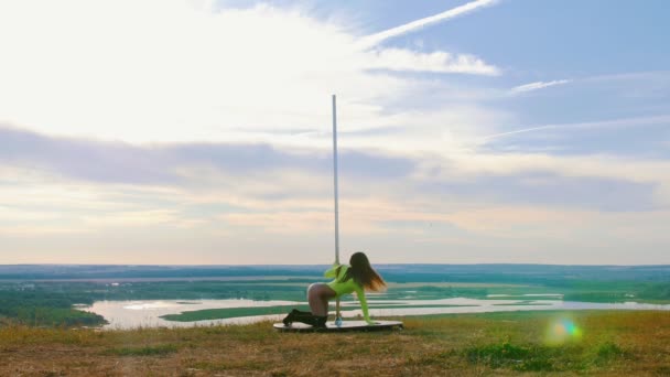 Pole dance on nature - sexy woman in green swimsuit dancing by the pole — Stock Video