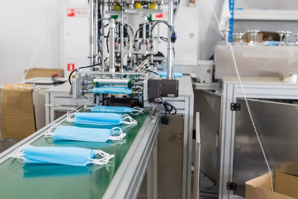 Przemysłowa produkcja ochronnych masek medycznych - maski na zakręcie produkcji — Zdjęcie stockowe