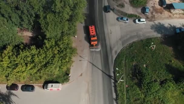 Stor orange maskine rydder asfalten med vandløb – Stock-video