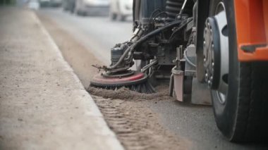 Büyük endüstriyel makine yol kenarındaki bir süpürgeyle beton tozu seviyesinde.