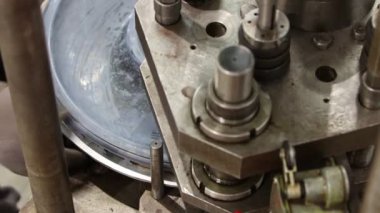 Metal diske baskı yapan bir makine