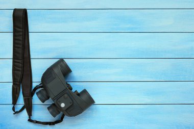 Mavi ahşap arka plan üzerinde dürbün.