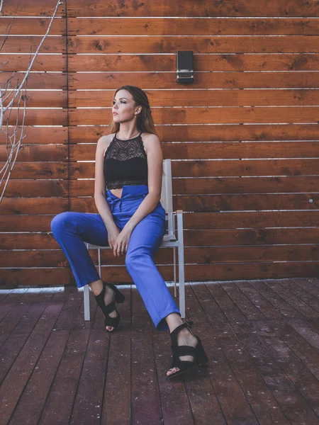 Bankta oturan güzel beyaz bir kızın portresi. Pahalı bir takım elbise ve makyaj yapıyor. Oturmuş birini bekliyor.