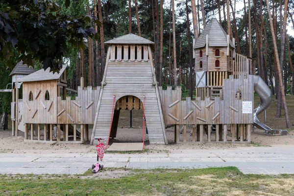 childrens playground made of wood in the form of a multi-storey castle