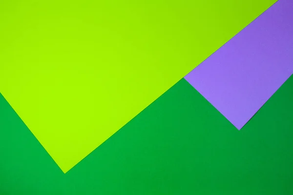 Color papers geometry flat composition background with colorful green and violet tones