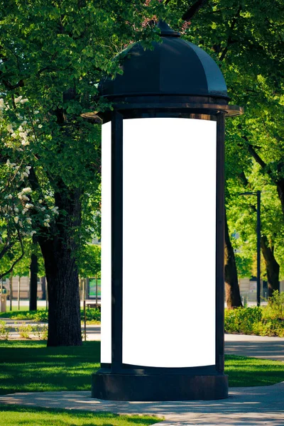 Mock up. Blank outdoor advertising column outdoors, public information board in the city.