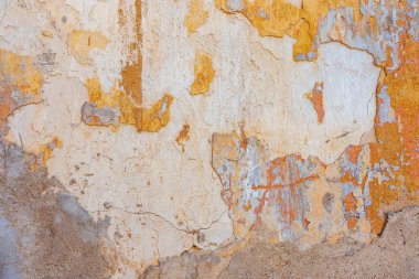 Kırık eski püskü sarı boyalı sıvalı soyulmuş duvar arka plan yıpranmış.