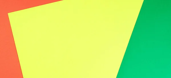 Color papers geometry flat composition background with yellow, green and red tones