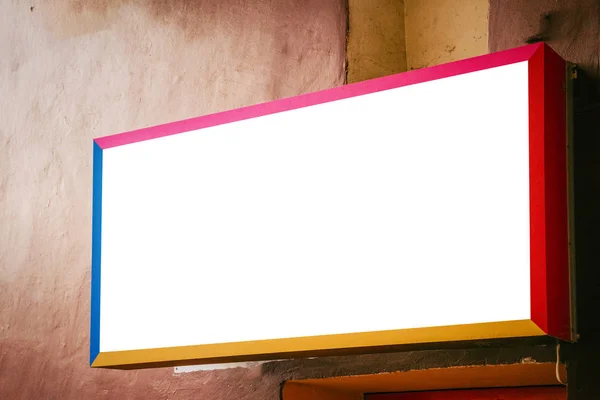 Mock up. Empty colorful signboard on old building wall