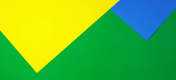 Color papers geometry flat composition background with yellow, green, and blue tones