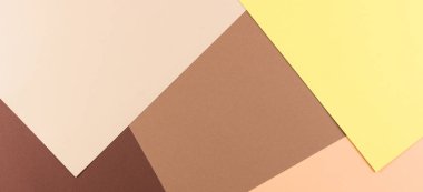 Renkli kağıtlar geometri kompozisyonu arka planı sarı, bej ve kahverengi tonlu.
