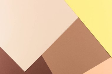 Renkli kağıtlar geometri kompozisyonu arka planı sarı, bej ve kahverengi tonlu.