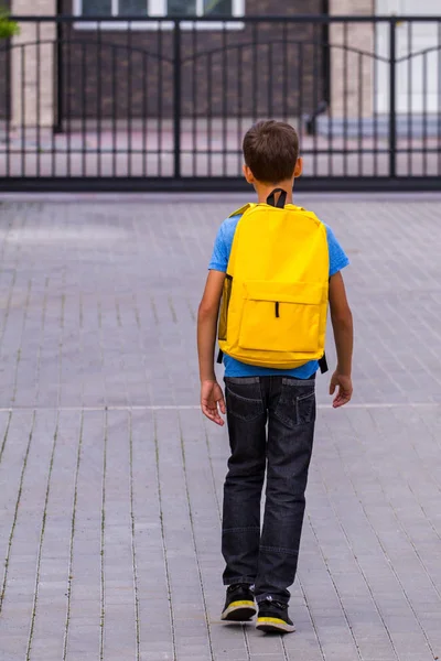 Αγόρι με κίτρινο σακίδιο σε εξωτερικούς χώρους. Πίσω όψη — Φωτογραφία Αρχείου