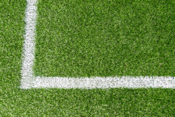 Green synthetic grass soccer sports field with white corner stripe line