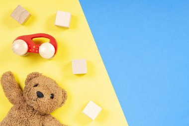Oyuncak ayı, ahşap otomobiller ve küpleri ile renkli oyuncaklar arka plan