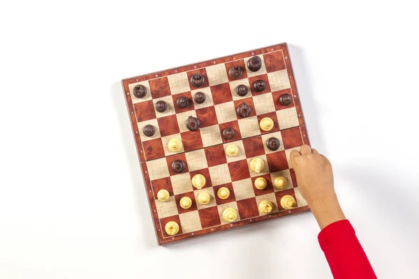 Kid hands over a chessboard playing chess game. Top view — Stock Photo, Image