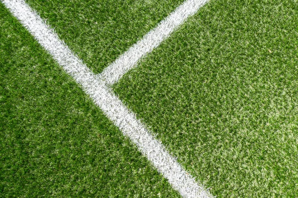 Green synthetic artificial grass soccer sports field with white corner stripe line — Stock Photo, Image