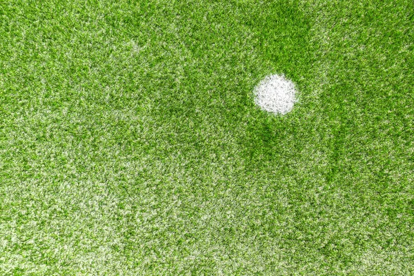 Green synthetic artificial grass soccer sports field with white penalty mark