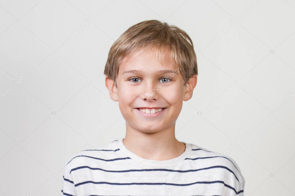 Smiling happy young boy looking at camera